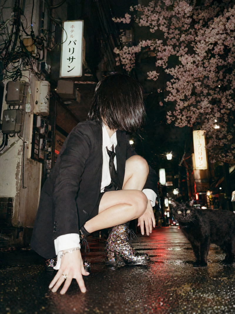 A cinematic candid night street photo in Tokyo shot from an extremely low ground