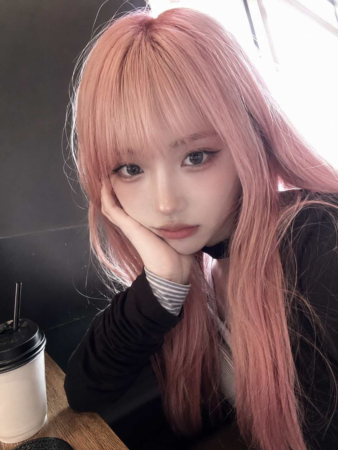 { "subject": { "description": "A young adult woman seated beside a café table, t